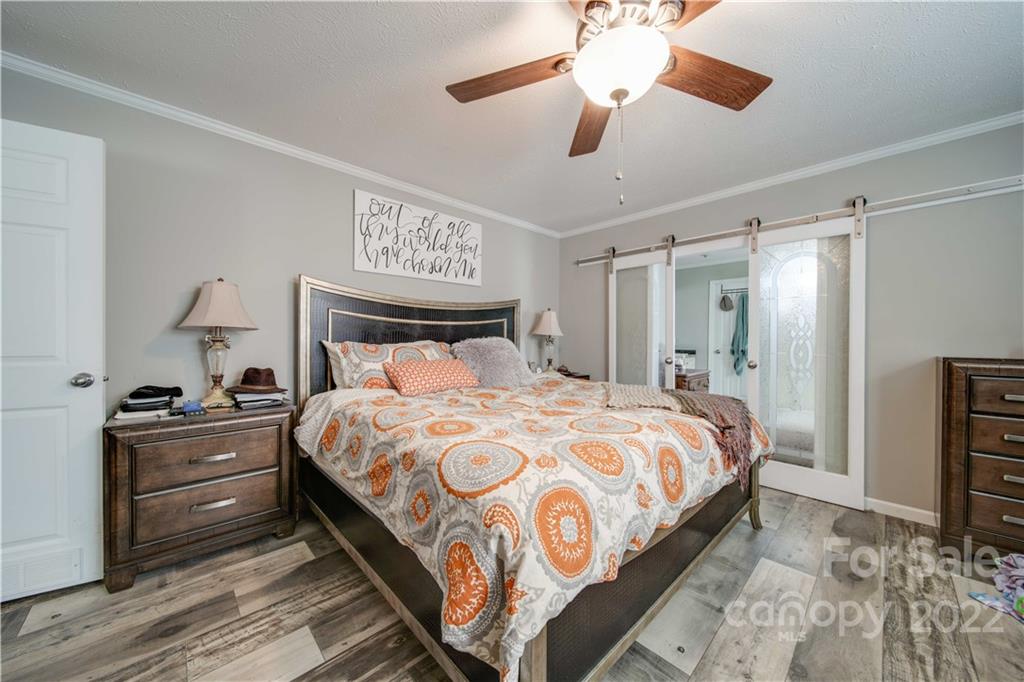 1540 Campbell Road Jefferson, SC 29718 - Photo 19 of 40 a bedroom with a bed and a chandelier