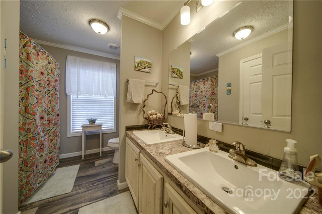 1540 Campbell Road Jefferson, SC 29718 - Photo 23 of 40 a bathroom with a double vanity sink mirror and shower