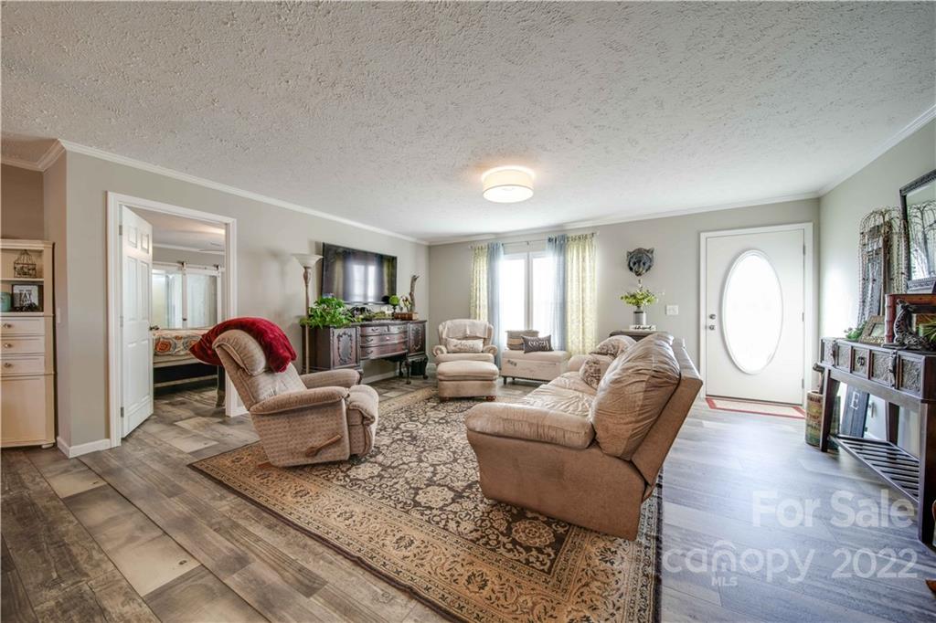 1540 Campbell Road Jefferson, SC 29718 - Photo 3 of 40 a living room with furniture a rug and a large window