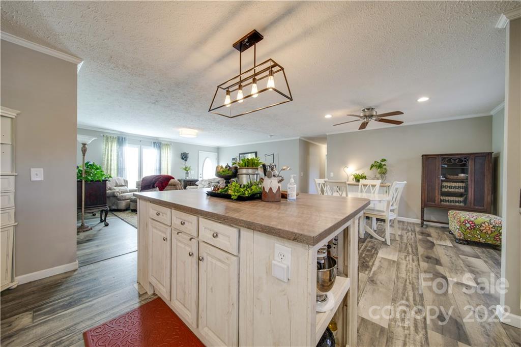 1540 Campbell Road Jefferson, SC 29718 - Photo 8 of 40 a kitchen with stainless steel appliances granite countertop a dining table chairs and wooden floor
