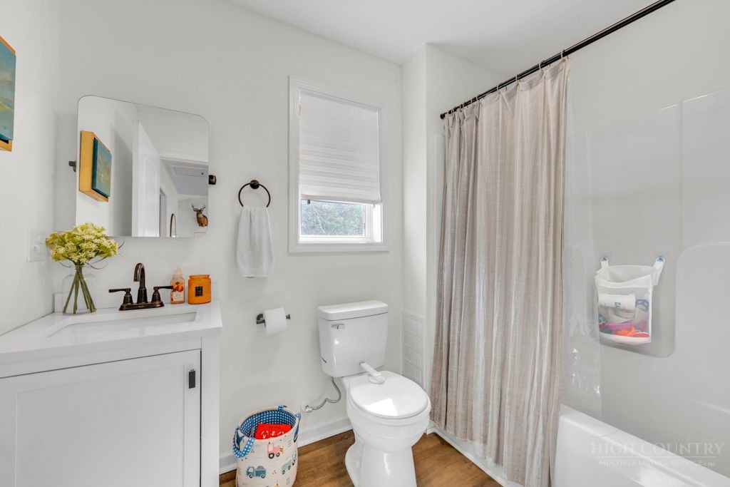 656 Mulatto Mountain Road West Jefferson, NC 28694 - Photo 29 of 35 a bathroom with a sink toilet and shower