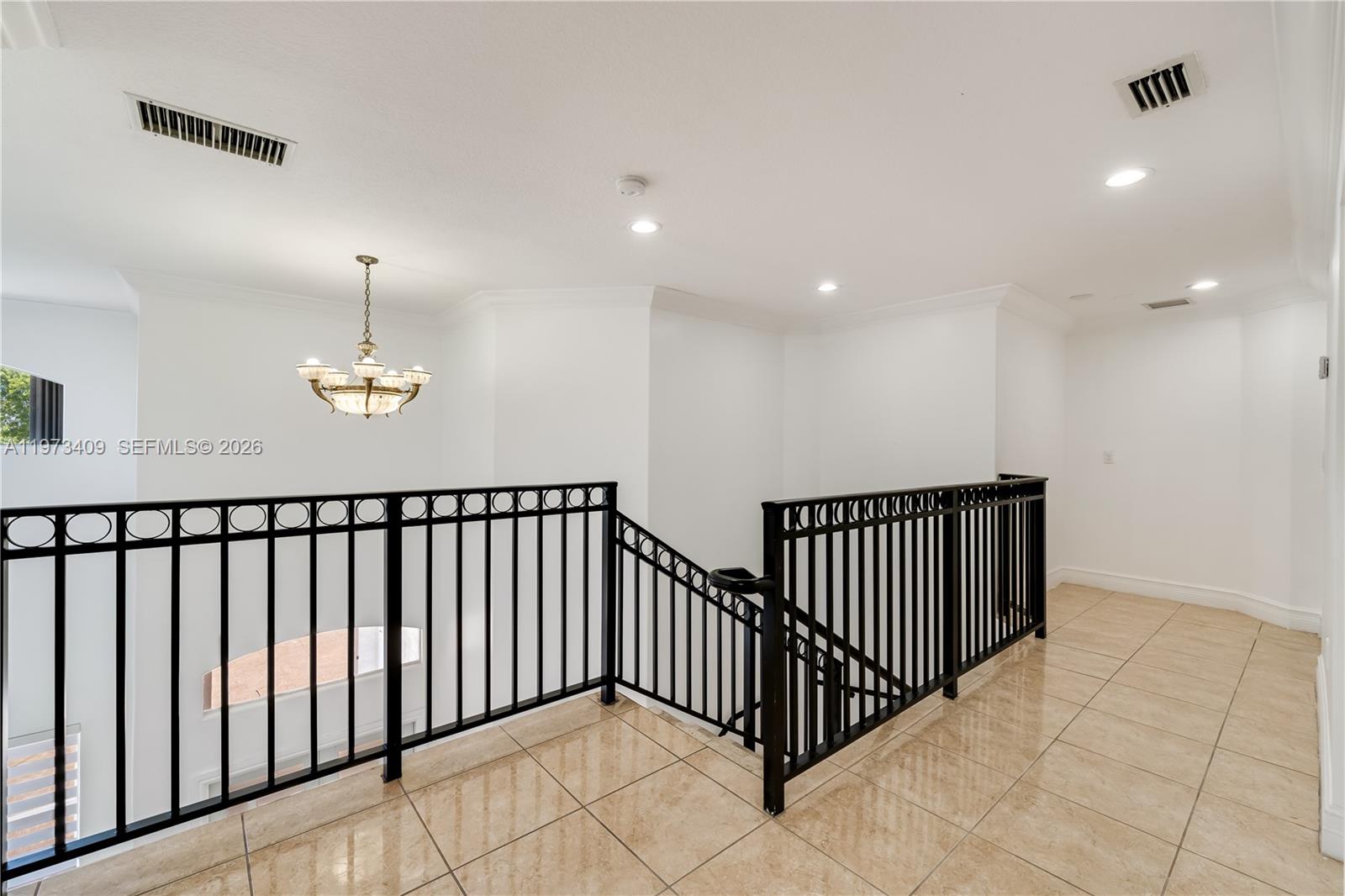 13050 Southwest 26th Street Miami, FL 33175 - Photo 15 of 43 a view of a hallway with chandelier
