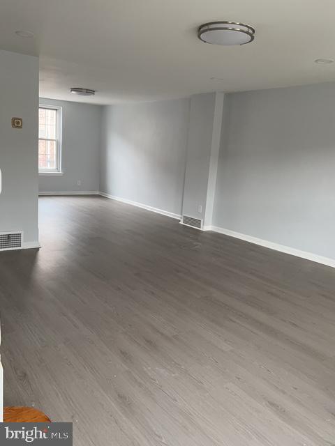 631 Anchor Street Philadelphia, PA 19120 - Photo 4 of 18 an empty room with wooden floor and windows