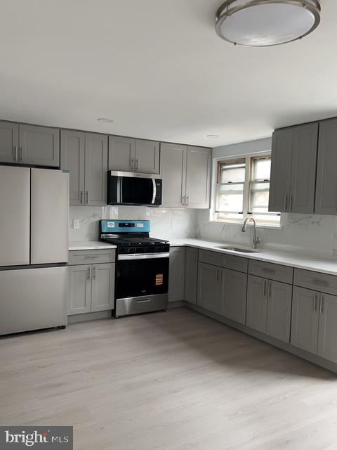 631 Anchor Street Philadelphia, PA 19120 - Photo 7 of 18 a kitchen with granite countertop a refrigerator a sink stainless steel appliances and cabinets