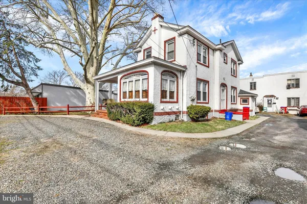 a front view of a residential houses with yard and trees