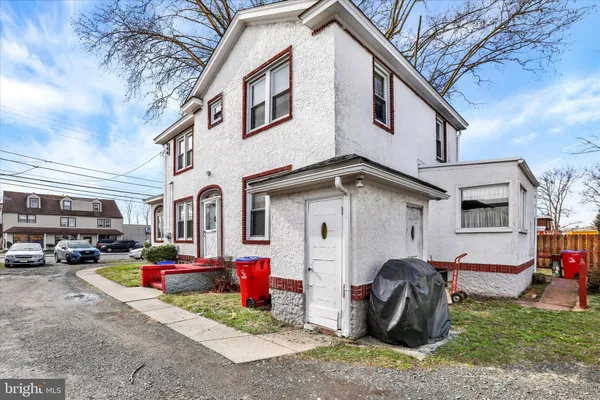 a front view of a house with a yard and outdoor seating