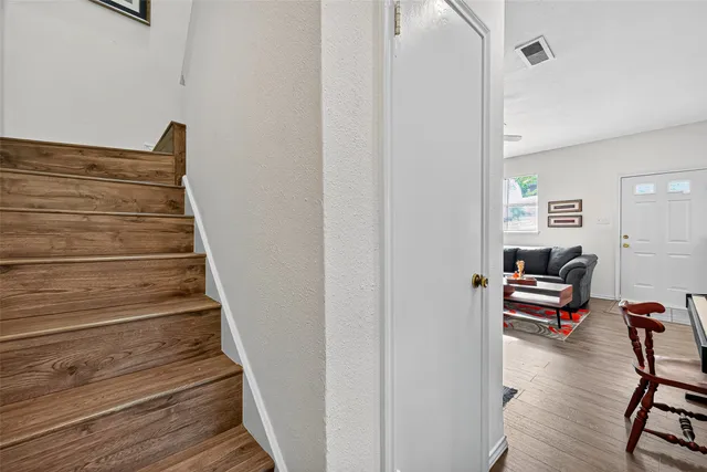 a view of entryway and hall with wooden floor