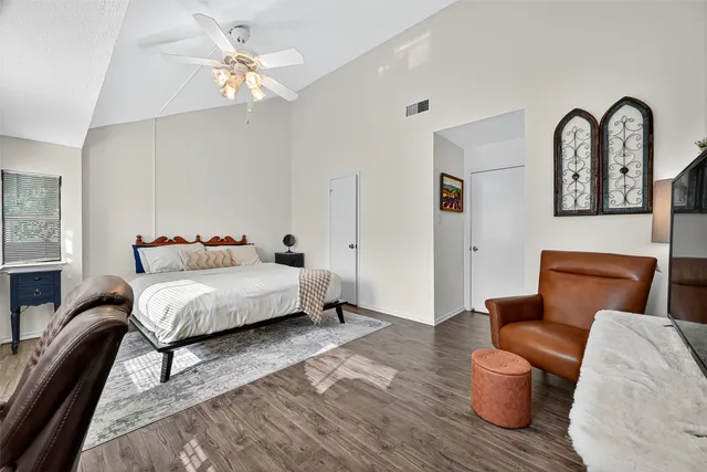 a bedroom with furniture and a chandelier
