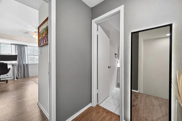 a view of a hallway with wooden floor
