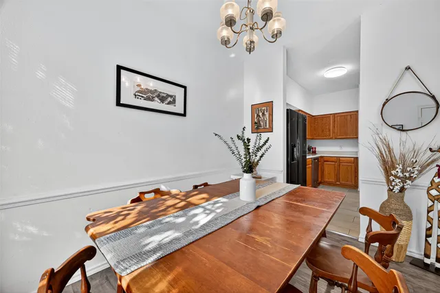 a living room with kitchen island furniture and a chandelier