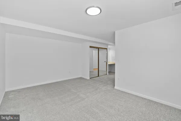 a view of an empty room and a window