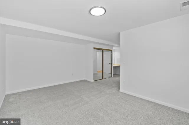 a view of an empty room and a window