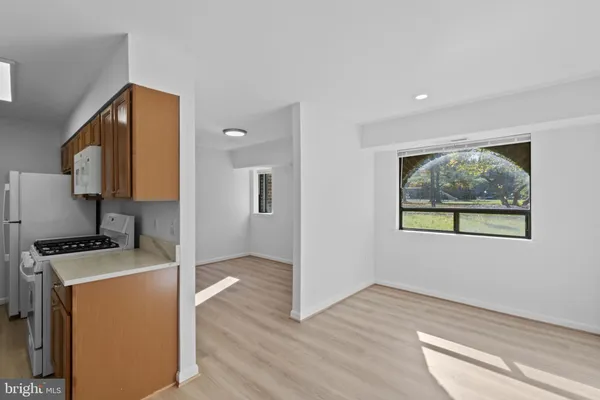 a view of a kitchen with wooden floor and electronic appliances