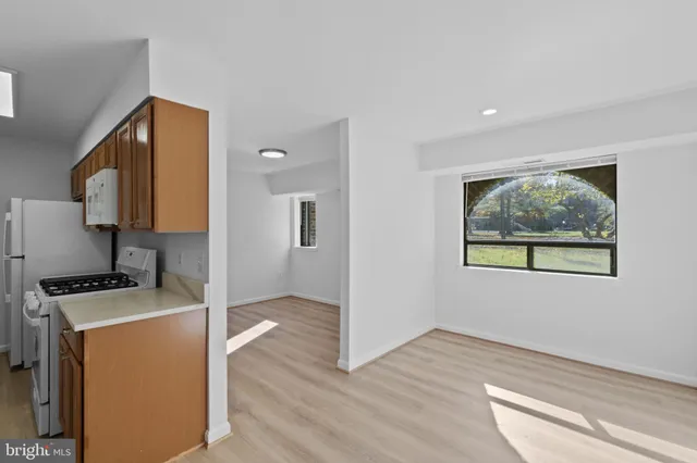 a view of a kitchen with wooden floor and electronic appliances