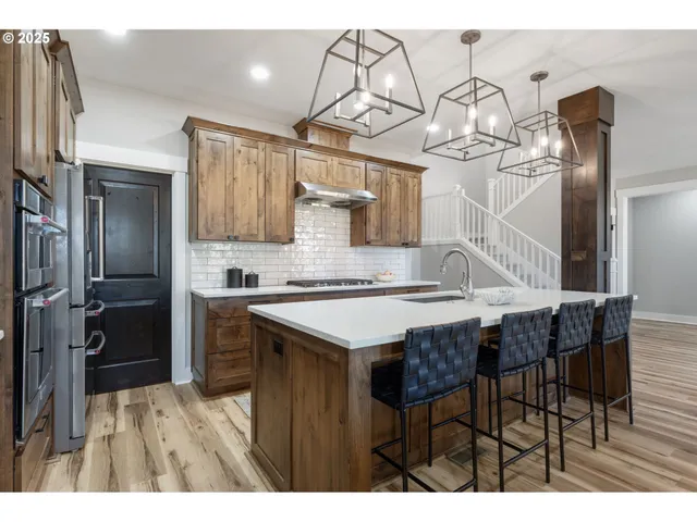 a kitchen with a table chairs refrigerator and cabinets