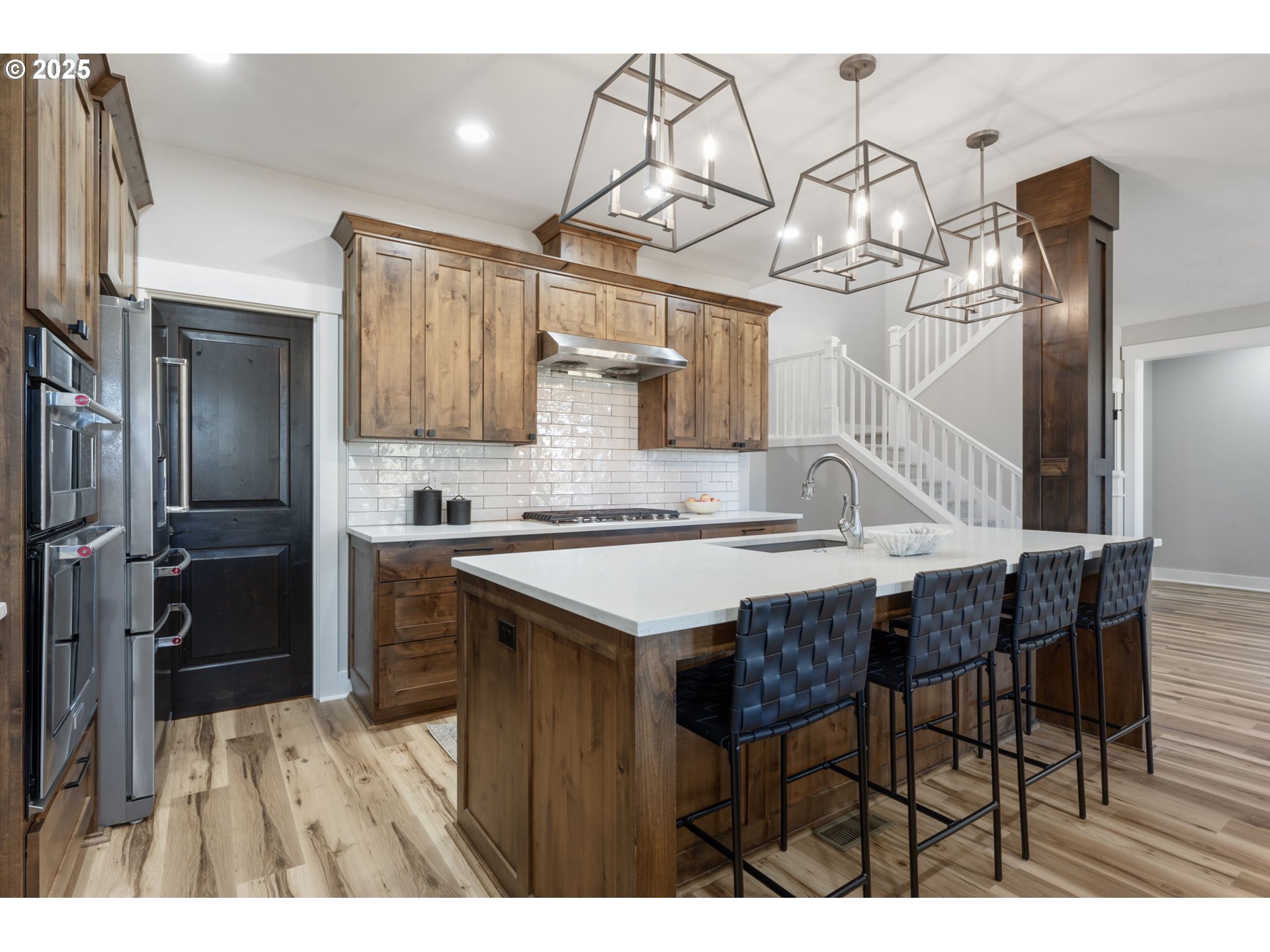 16486 Southwest Ranchview Road Powell Butte, OR 97753 - Photo 11 of 44 a kitchen with a table chairs refrigerator and cabinets