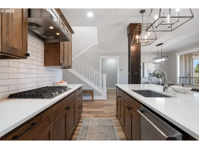 a kitchen that has a sink and a stove