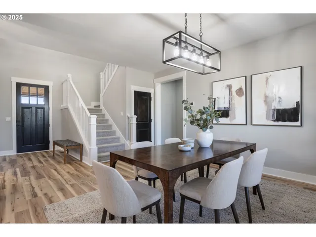 a view of a dining room with furniture and a chandelier