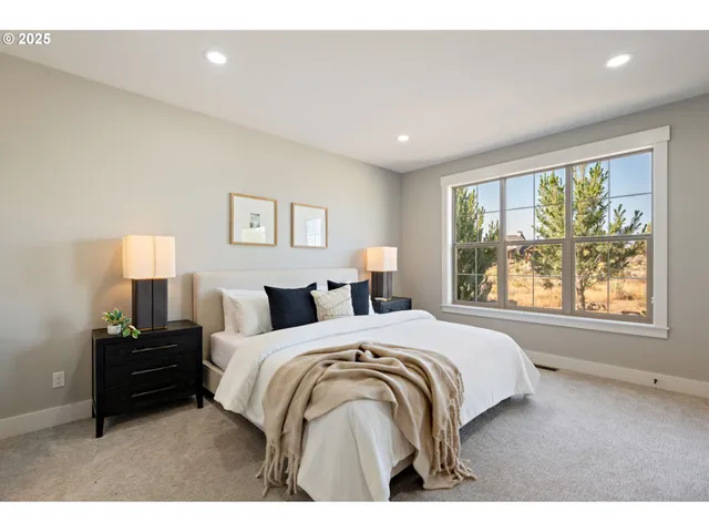 a spacious bedroom with a bed and a large window