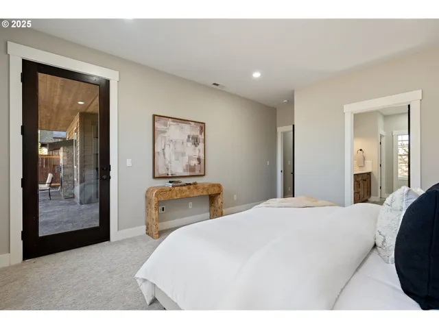 a bedroom with a bed and a large mirror