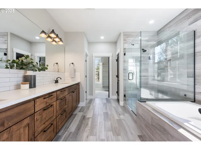 a bathroom with a double vanity sink mirror and shower