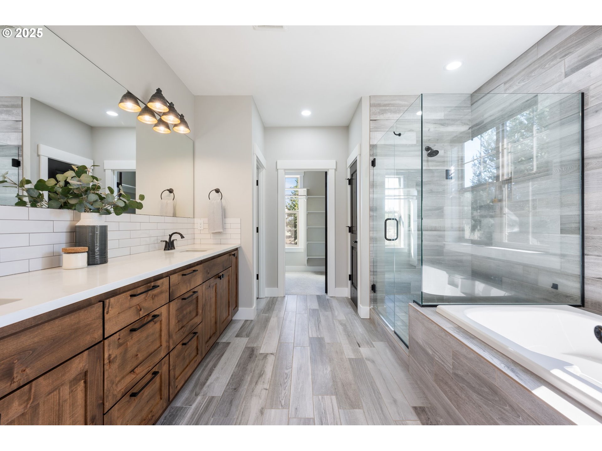 16486 Southwest Ranchview Road Powell Butte, OR 97753 - Photo 20 of 44 a bathroom with a double vanity sink mirror and shower