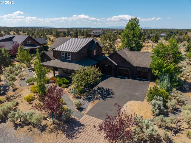 an aerial view of a house with a yard and lake view