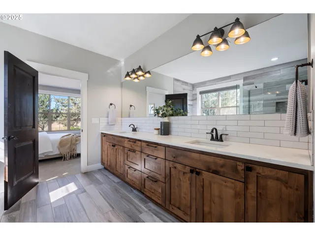 a bathroom with a sink double vanity granite and a mirror