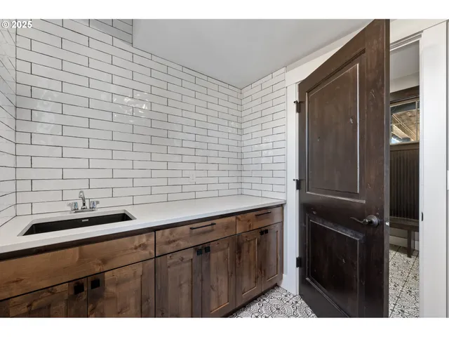 a kitchen with a sink and cabinets