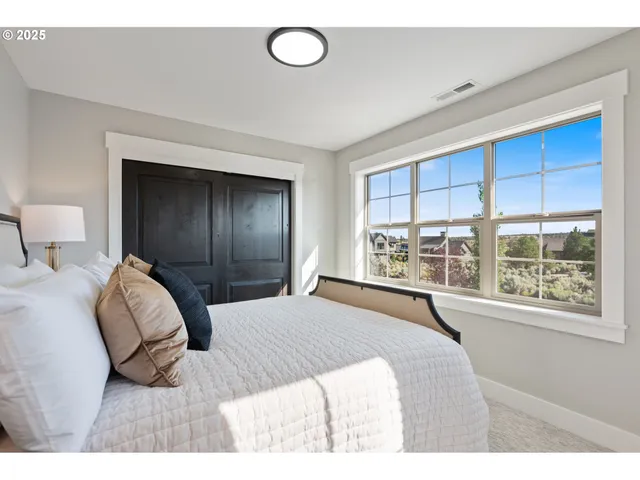 a bedroom with a bed and a potted plant