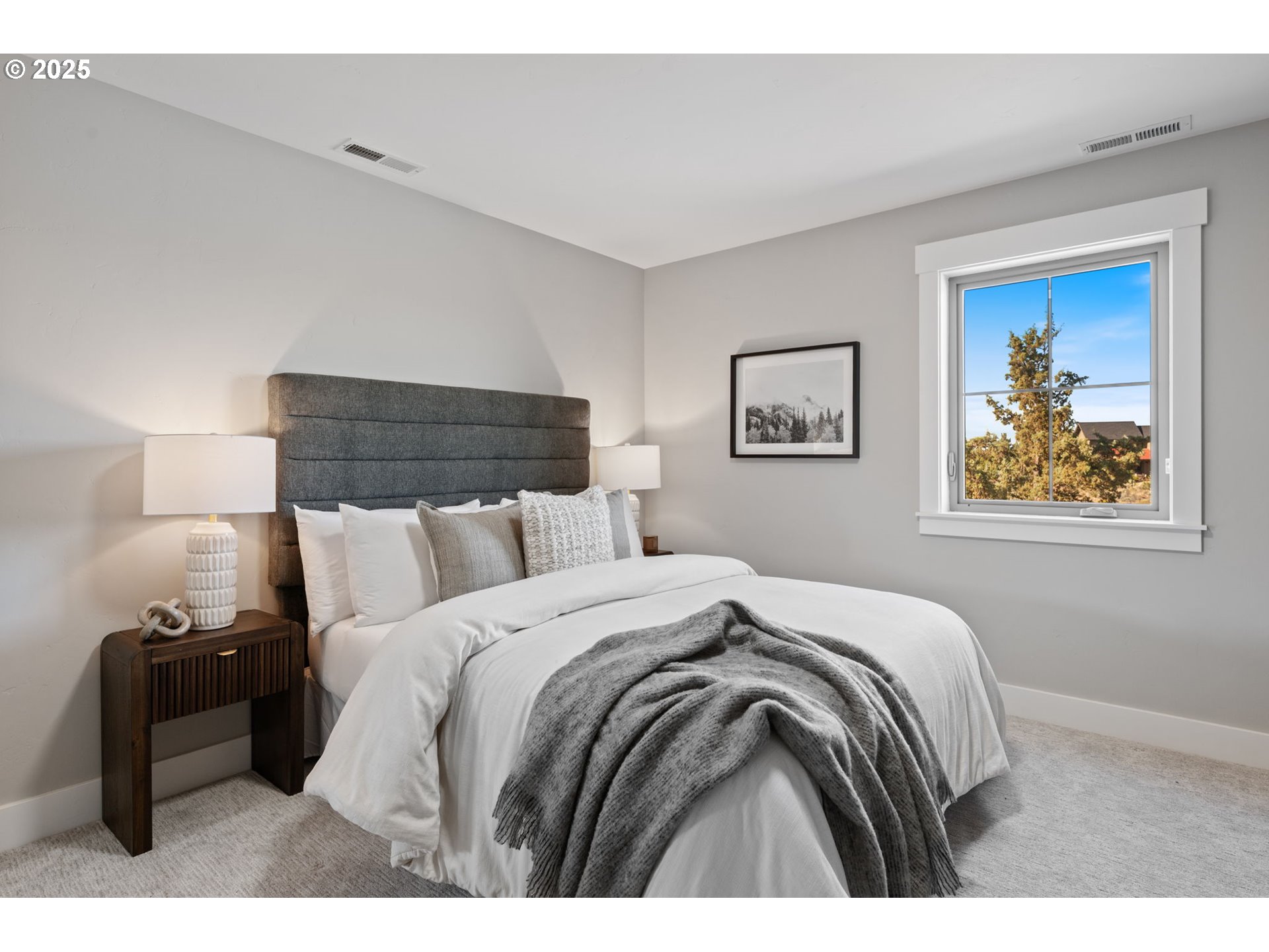 16486 Southwest Ranchview Road Powell Butte, OR 97753 - Photo 34 of 44 a bed room with a bed and painting on the wall