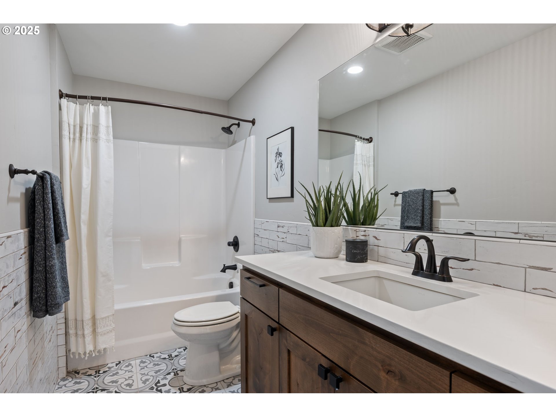 16486 Southwest Ranchview Road Powell Butte, OR 97753 - Photo 35 of 44 a bathroom with a granite countertop sink a toilet a mirror a vanity and shower