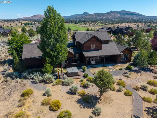 an aerial view of a house with a yard and sitting area