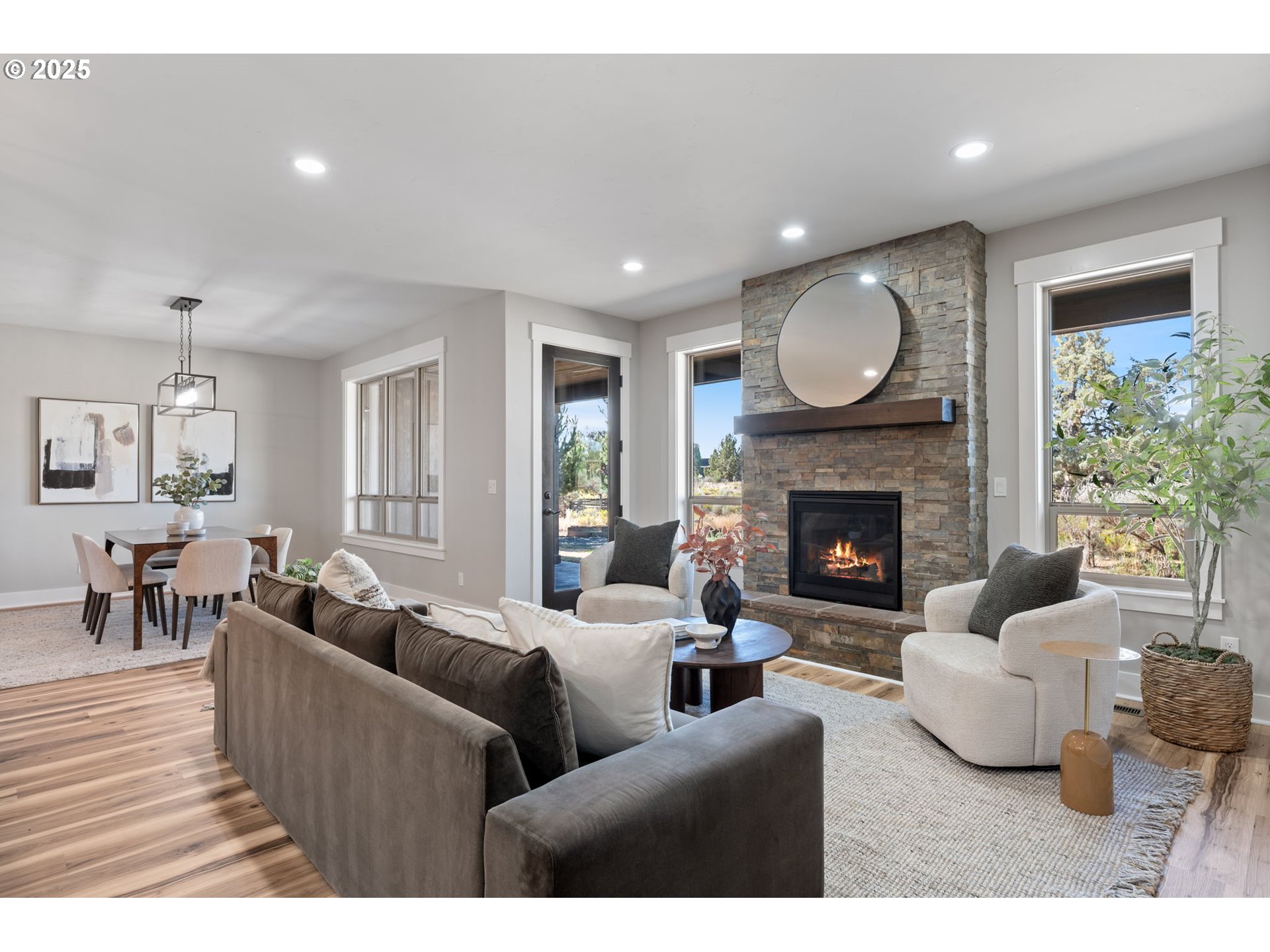 16486 Southwest Ranchview Road Powell Butte, OR 97753 - Photo 6 of 44 a living room with furniture fireplace and a large window