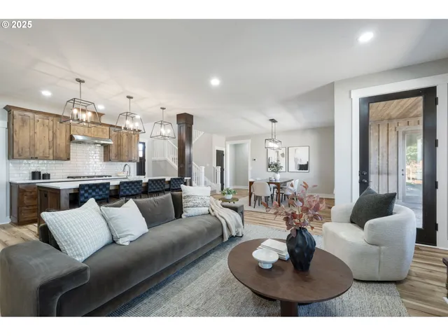 a living room with furniture kitchen and a chandelier