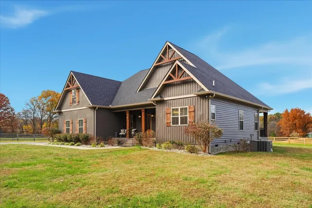 a front view of house with yard and green space
