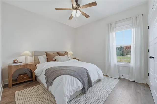a spacious bedroom with a bed and a window