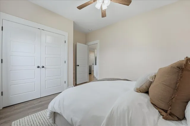 a bedroom with a bed and a chandelier