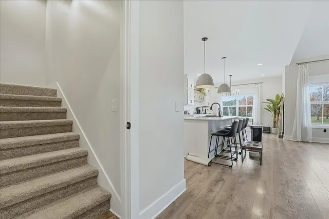 a view of a room with furniture and wooden floor