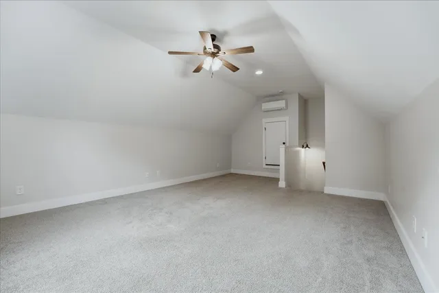an empty room with a ceiling fan and window