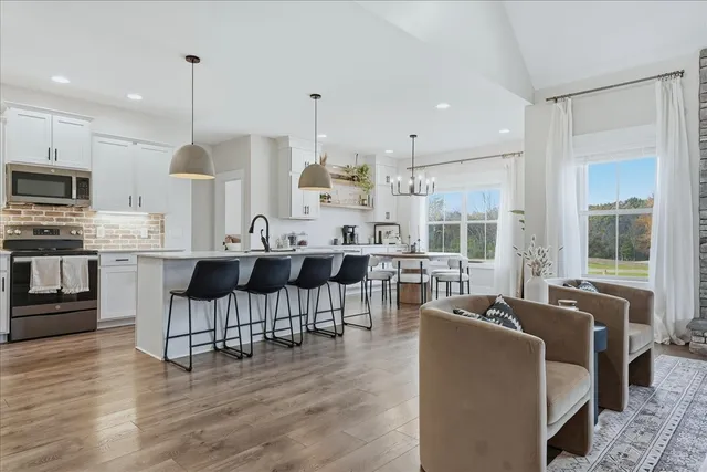 a large kitchen with cabinets table and chairs