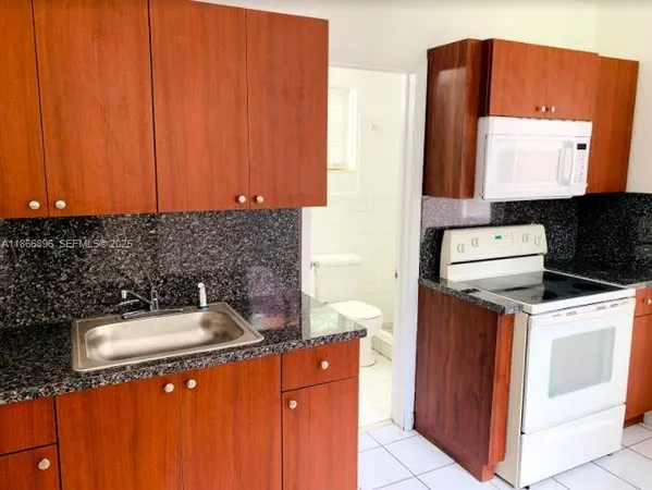 a kitchen with a sink cabinets and appliances