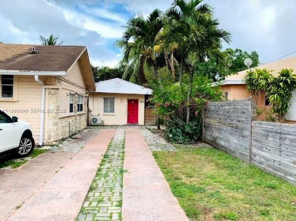 a front view of a house with a garden
