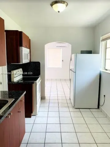 a kitchen with a refrigerator and a stove