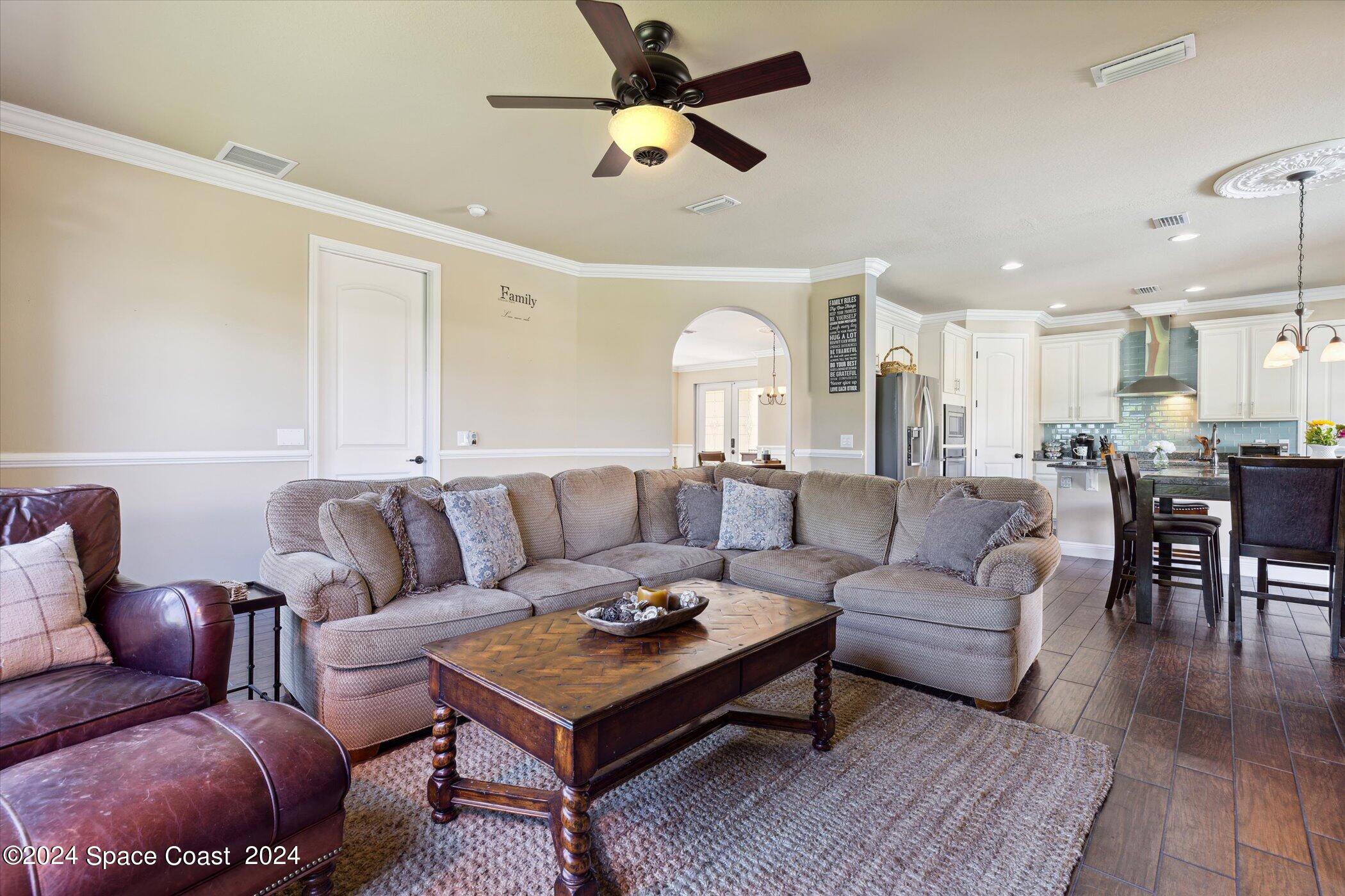 110 Poinsetta Street Indialantic, FL 32903 - Photo 23 of 67 a living room with furniture kitchen view and a chandelier