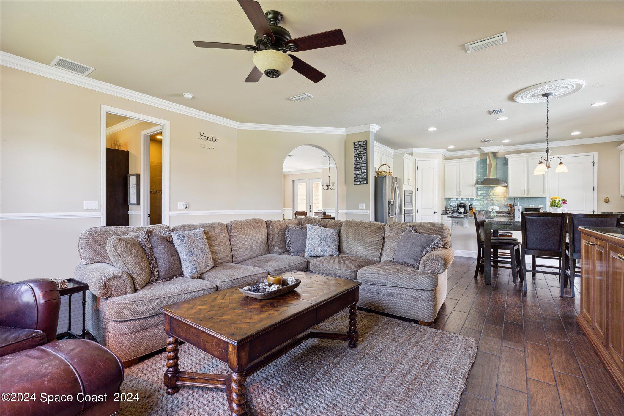 110 Poinsetta Street Indialantic, FL 32903 - Photo 24 of 67 a living room with furniture kitchen view and a chandelier