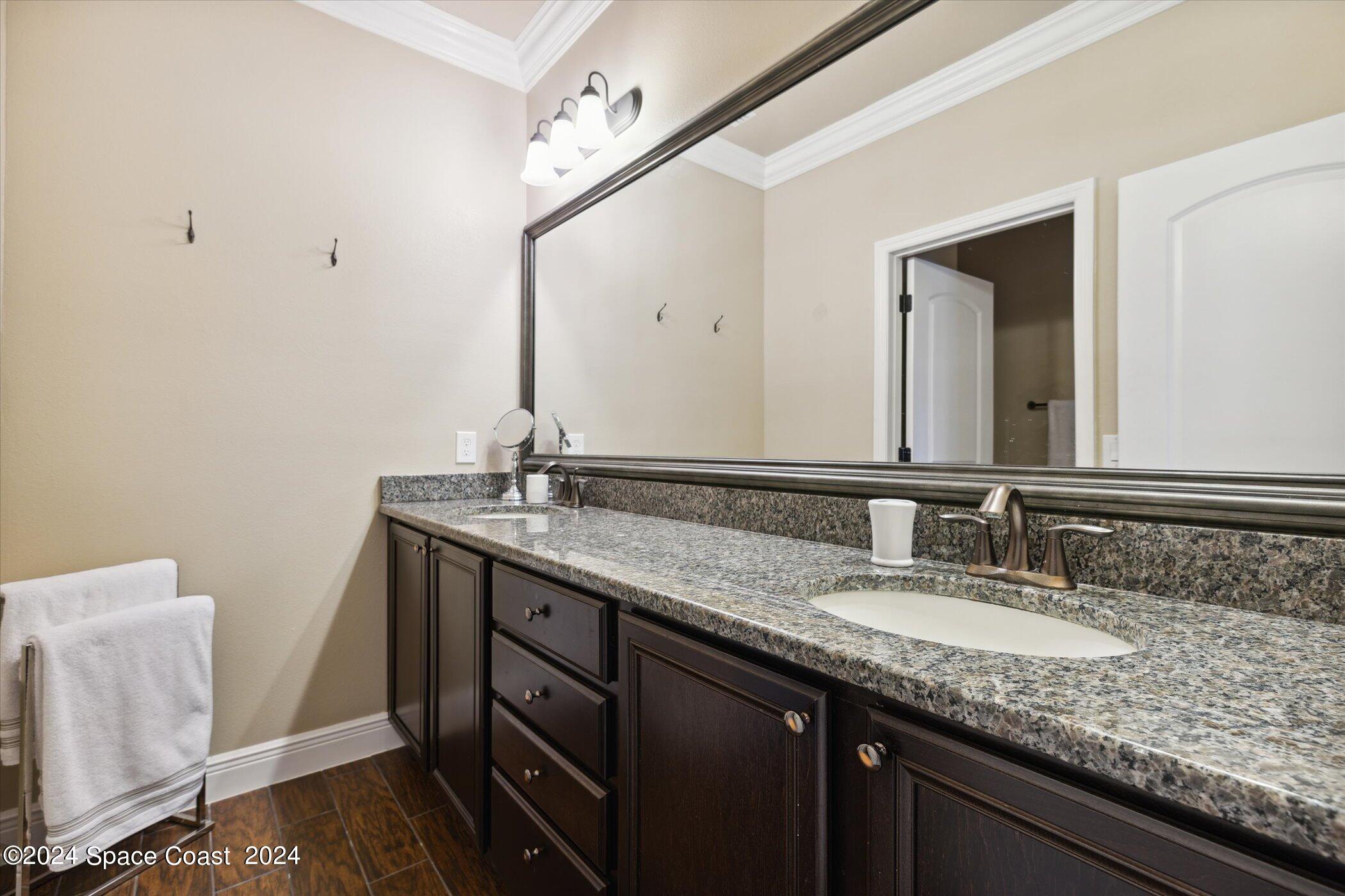 110 Poinsetta Street Indialantic, FL 32903 - Photo 40 of 67 a bathroom with a granite countertop sink and a mirror