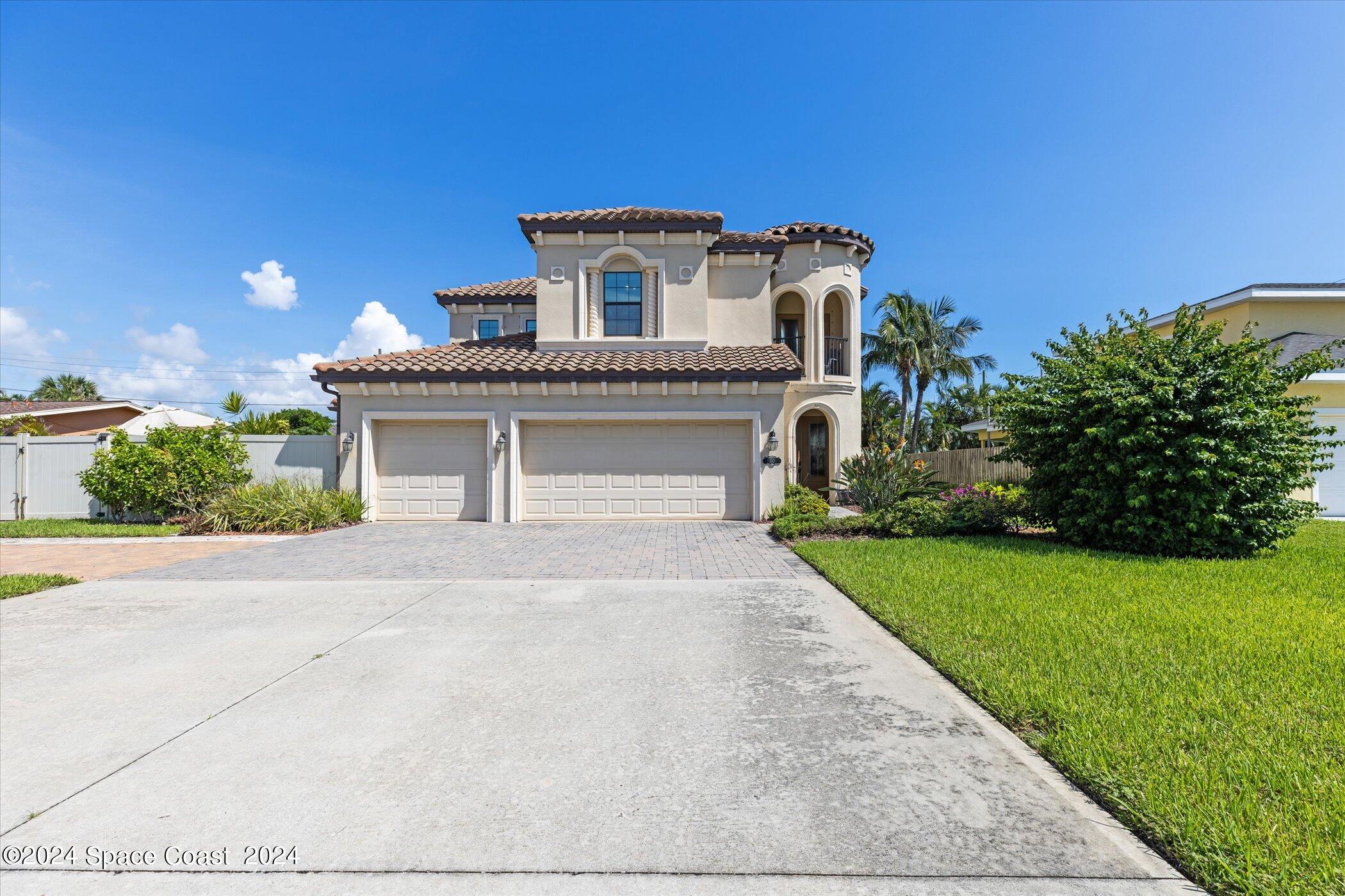 110 Poinsetta Street Indialantic, FL 32903 - Photo 4 of 67 a front view of a house with a garden and plants