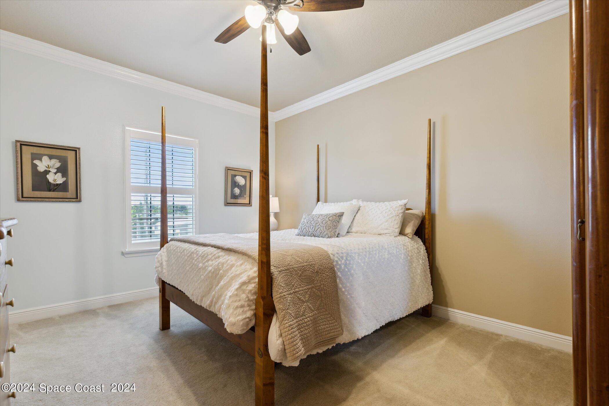 110 Poinsetta Street Indialantic, FL 32903 - Photo 43 of 67 a bed room with a bed and a chandelier