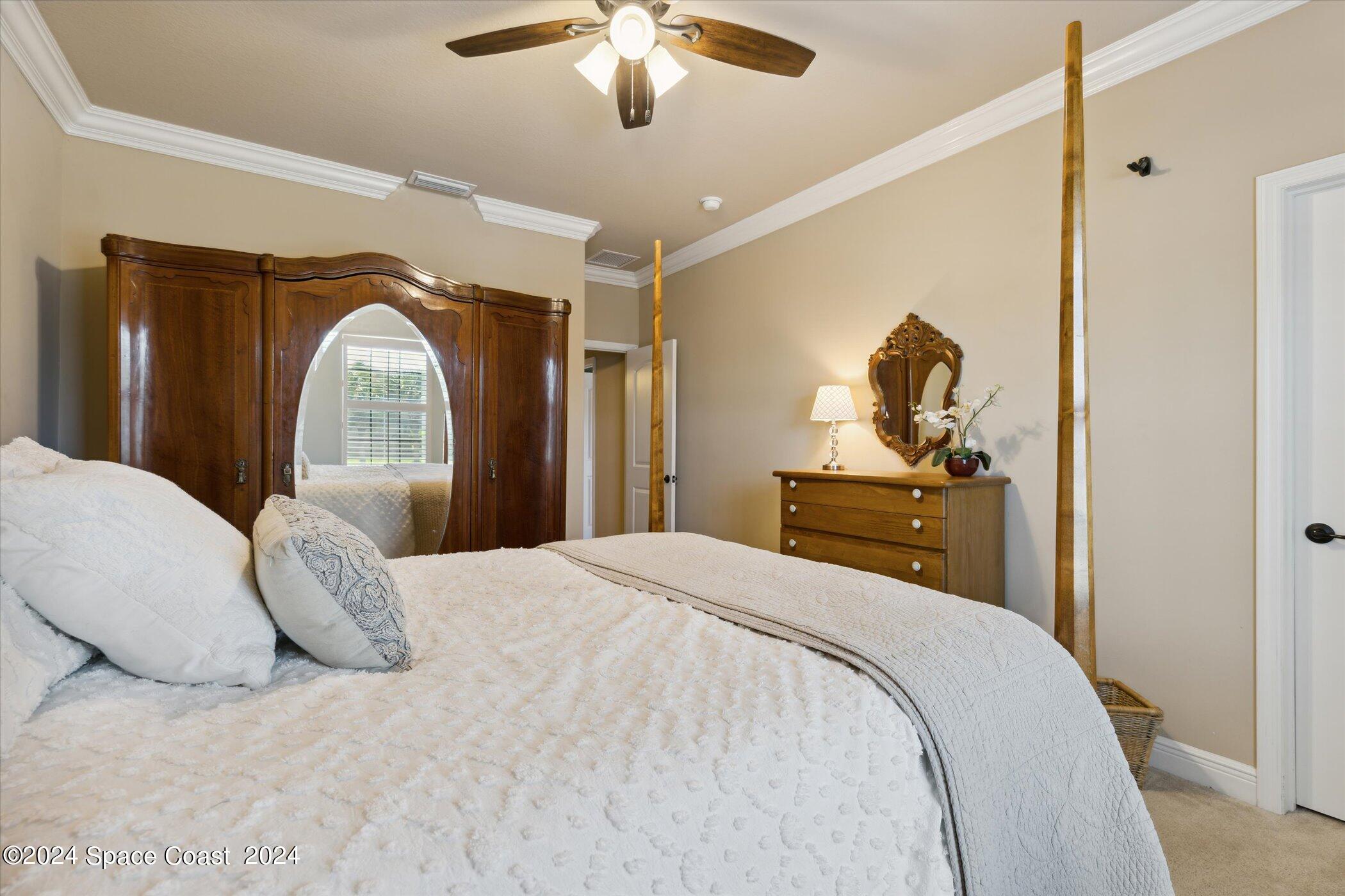 110 Poinsetta Street Indialantic, FL 32903 - Photo 44 of 67 a bedroom with a bed and a chandelier